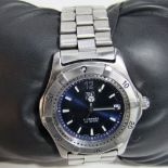 A Tag Heuer automatic 200 metre divers watch with blue dial, button markers, original strap with