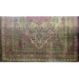 A large Persian Mashed carpet with all over floral design within deep running border, 300x245cm