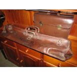 A vintage leather cricket bag with brass fittings together with a further leather travel/sample bag