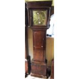 A simple 18th century longcase clock, the square cut hood enclosing a square brass dial with applied