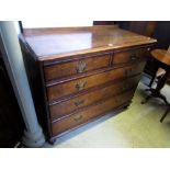 A Georgian oak chest of three long and two short drawers, crossbanded in walnut and with brass plate