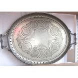 A large silver plated twin handled tray, with scrolled handles, beaded and pierced borders, the