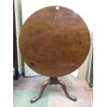 A George III mahogany snap top table, the massive one piece top 90 cm diameter raised on a bird cage