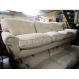 A very high quality sofa to seat six in a traditional country house style, raised on turned supports