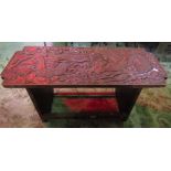 A Chinese red lacquered occasional table of rectangular form with dragons, clouds and pearl