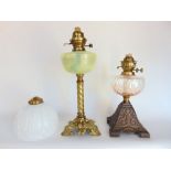A good quality cast brass oil lamp with vaseline glass reservoir, barley twist column and Rococo
