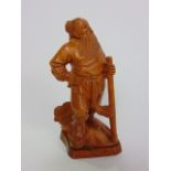 A Japanese boxwood carving of a standing bearded gentleman, possibly of a farming or mining