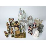 A collection of Goebel Hummell figures including a little girl knitting, a boy with umbrella, etc, a