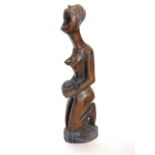 An African tribal carved figure of a kneeling nude woman with open mouth holding a dish, 40 cm