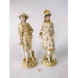 A pair of late 19th century continental figures of male and female characters with painted and