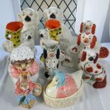 A collection of 19th century and later Staffordshire dogs including a jug in the form a begging