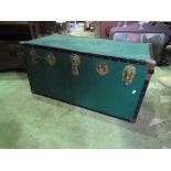 A good quality travelling trunk with green canvas band and steel fittings