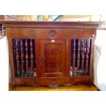 An 18th century walnut dole cupboard, the central door with quarter veneered panels with turned