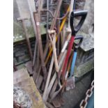 A large quantity of vintage garden tools, many with ashwood handles including spades, pick axes,