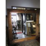 A substantial 19th century style wall mirror of square cut form with bevelled edge mirror plate, the