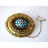 A yellow metal ornate brooch set with turquoise and seed pearls, 10.5g