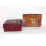 A good leather box with hinged lid fitted with a recessed handle and Bramah lock, 31 cm wide