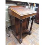 A Georgian mahogany davenport with enclosed base raised on a pair of turned column supports, the