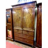 An early 19th century mahogany linen press, the lower section enclosed by two long and two short