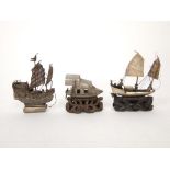 Three various Chinese silver ships, two upon carved wooden bases