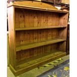 A stripped and waxed pine open bookcase fitted with three shelves with three quarter gallery, 150