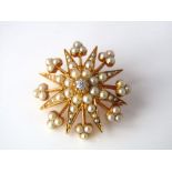 A seed pearl and diamond brooch/pendant with dual fitting of starburst design, in unmarked yellow