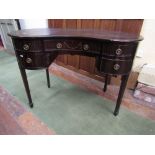 A good quality Edwardian mahogany kidney shaped writing desk fitted with five drawers with carved