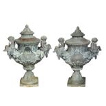 A pair of large classical lead urns, the bodies of vase shaped form surmounted by cherubs and