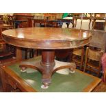 An early 19th century mahogany centre table, the circular top 140 cm diameter approx raised on a