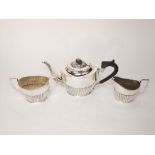 A three piece silver tea set, teapot, sugar basin and milk jug, each of oval form with fluted