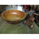 A large polished cedar wood bowl brass banded, 75 cm wide, together with a vintage child's toy