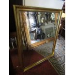 A rectangular overmantle mirror, the bevelled edge mirror plate within a moulded gilded frame, 112