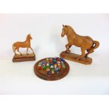 Two carved wooden horses, one of Italian origin, together with a marble game.