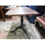 A Georgian mahogany occasional table with turned vase shaped pillar and tripod