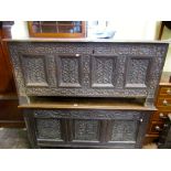 An 18th century oak coffer with hinged lid and panelled frame, the front elevation enclosing four