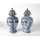 Pair of Qing Dynasty oriental blue and white vases and covers of shouldered form with alternating