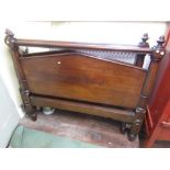 A Victorian mahogany bedstead with pointed arched panels and turned supports