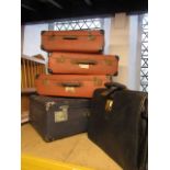 A collection of vintage suitcases, attache case, etc