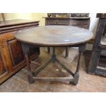 An 18th century oak cricket table on simple column supports set beneath a circular top 80 cm in