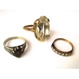 A 9ct ring set with a large faceted citrine, size N/O and two further rings, one in 9ct gold, 15.