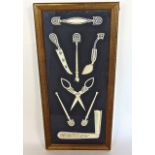Interesting framed selection of carved ivory ladies dressing tools to include a folding comb,