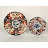 A large 19th century Imari charger of usual form with shaped rim and flowering trees detail, 40cm
