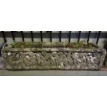A heavily weathered reconstituted planter in a medieval style with carved character frieze, 83cm