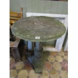 A well weathered marble table, the circular segmented top raised on a central pillar and tricorn