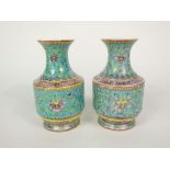A pair of polychrome oriental vases with floral and scrolling decoration on turquoise and yellow