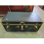 A travelling cabin trunk of traditional form with brass banded borders