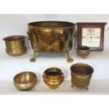 A 19th century brass log bucket, with twin lion head handles and cast paw feet; together with five