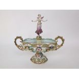 A 19th century continental table centre piece in the form of a two handled oval vase with floral