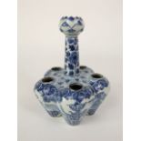 An oriental blue and white flower holder in the 18th century Dutch Delft manner, of lobed form