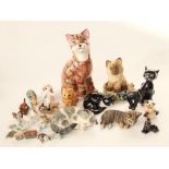 A collection of ceramic models of cats including a large Price Kensington example of a tabby cat,